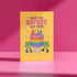 5x7 inch birthday greeting card with a yellow background featuring the phrase “Have the Gayest Day Ever” in bold pink text, a rainbow birthday cake with candles spelling “SLAY,” and two green frogs wearing colorful platform boots. Card includes confetti details and a white envelope. Printed on 120lb silk cover stock. The inside message reads: “Sashay into this new age with zero regrets and maximum glitter.”