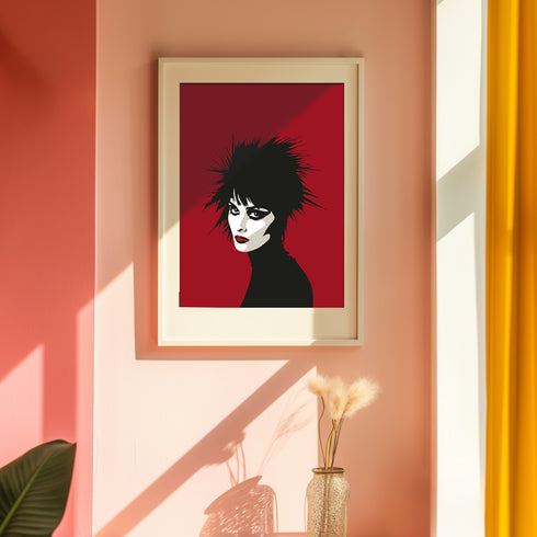 A minimalist portrait of Siouxsie Sioux against a deep red background. The image shows her signature spiky black hair, pale white face, dramatic black eye makeup, and bold red lips in a simplified, high-contrast style. Her face is shown in profile, turned slightly to showcase her distinctive features and punk aesthetic.