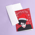 A festive greeting card featuring an illustration of Robert Smith from The Cure, wearing a Santa hat. The card has a red background with white snowflakes and the text "Pictures of Yule" at the top, playfully referencing the song "Pictures of You." The card merges gothic and holiday themes for a unique seasonal twist.