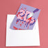 A 5x7 birthday card with a horror-comedy design. The front features the word "20s" in pink gooey lettering with a bloody knife stabbing through it, surrounded by red blood splatter. Below it reads "YOU KILLED IT!" in dripping red font, set against a purple background with a rainbow foil tinsel curtain behind it. Inside, the right panel says "HERE'S TO THE NEXT VICTIM: YOUR THIRTIES!" with dripping red blood at the top and a pink cherry garland background.