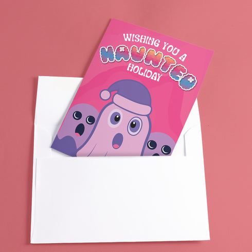 Holiday card with pink background featuring cartoon ghosts. Main ghost wears purple Santa hat. Text reads "WISHING YOU A HAUNTED HOLIDAY" in colorful, playful font. Overall cute and spooky design blending Halloween and Christmas themes. Inside message: "Eat, Drink, and Be Scary.