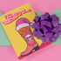 Colorful Christmas card with a yellow background. Features a stylized cowboy boot decorated with a skull, hearts, and swirls in pink, orange, and purple. The boot wears a pink Santa hat. A green cactus stands beside the boot. Top text reads 'Y'ALL BEWARE, CHRISTMAS IS HERE!' in red, wavy letters. Card has a purple border. Inside message: 'May Your days be merry, bright and full of southern delight.' The design blends Christmas, Western, and Day of the Dead motifs for a unique, playful holiday greeting