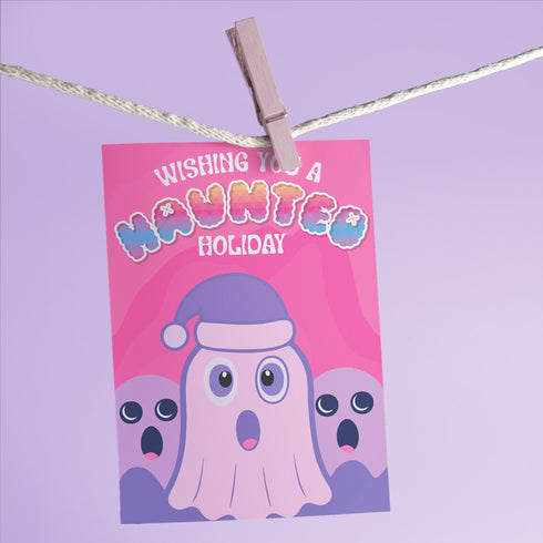 Holiday card with pink background featuring cartoon ghosts. Main ghost wears purple Santa hat. Text reads "WISHING YOU A HAUNTED HOLIDAY" in colorful, playful font. Overall cute and spooky design blending Halloween and Christmas themes. Inside message: "Eat, Drink, and Be Scary.