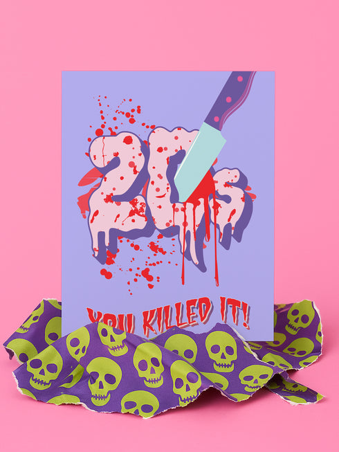 A 5x7 birthday card with a horror-comedy design. The front features the word "20s" in pink gooey lettering with a bloody knife stabbing through it, surrounded by red blood splatter. Below it reads "YOU KILLED IT!" in dripping red font, set against a purple background with a rainbow foil tinsel curtain behind it. Inside, the right panel says "HERE'S TO THE NEXT VICTIM: YOUR THIRTIES!" with dripping red blood at the top and a pink cherry garland background.