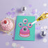 Quirky birthday card with teal background. Pink-purple cake topped by large cartoon eyeball. Three eyeball-shaped balloons float above, each with blue iris and pink edges. Inside message: "Eye Think You're Amazing. Happy Birthday". Playful design combines celebration with surreal humor, creating a memorable and slightly bizarre greeting. Whimsical imagery and pun offer a unique twist on traditional birthday wishes.