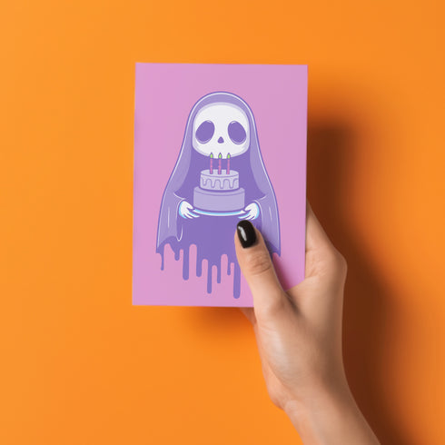 Birthday card featuring a cute cartoon grim reaper holding a birthday cake on pink background. The reaper wears a purple cloak and has a white skull face. It's carrying a small purple cake with three lit candles. The reaper's cloak drips like melting icing at the bottom. Ideal for Halloween birthdays or gothic-themed celebrations. Inside greeting: "Hope your B-day is spooky AF and sweet as cake!"