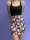High-waisted bodycon mini skirt featuring abstract floral print in coral pink, white and charcoal grey on black background. Fitted silhouette with stretch fabric and above-knee length.