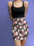 High-waisted bodycon mini skirt featuring abstract floral print in coral pink, white and charcoal grey on black background. Fitted silhouette with stretch fabric and above-knee length.