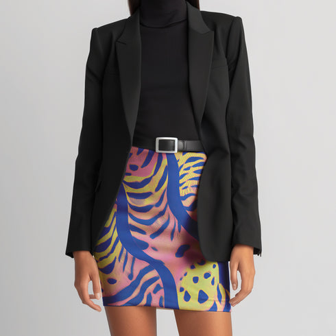 High-waisted mini skirt with a vibrant pastel tiger stripe pattern in electric blue, soft pink, yellow, and violet. The bodycon silhouette hugs curves with a comfy elastic waistband and stretch fabric. Available in smooth performance fabric or glitter finish. A maximalist fashion piece for festivals, summer outfits, and ravewear.