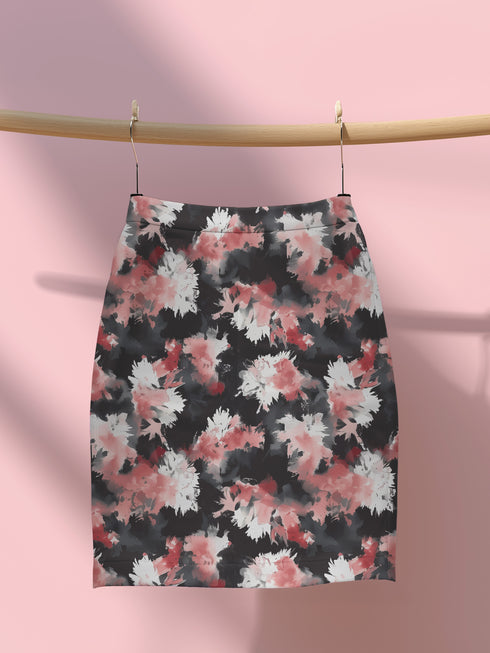 High-waisted bodycon mini skirt featuring abstract floral print in coral pink, white and charcoal grey on black background. Fitted silhouette with stretch fabric and above-knee length.