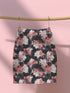 High-waisted bodycon mini skirt featuring abstract floral print in coral pink, white and charcoal grey on black background. Fitted silhouette with stretch fabric and above-knee length.