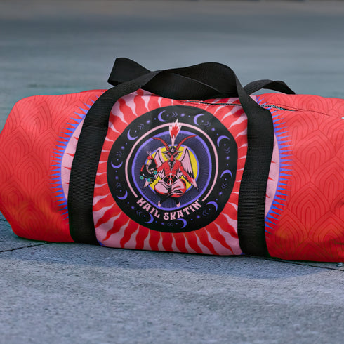 Red cylindrical roller skating duffle bag with black straps, featuring a prominent circular emblem with a colorful Baphomet design and "Hail Skatin" text. Includes mesh side pocket and adjustable padded shoulder strap.