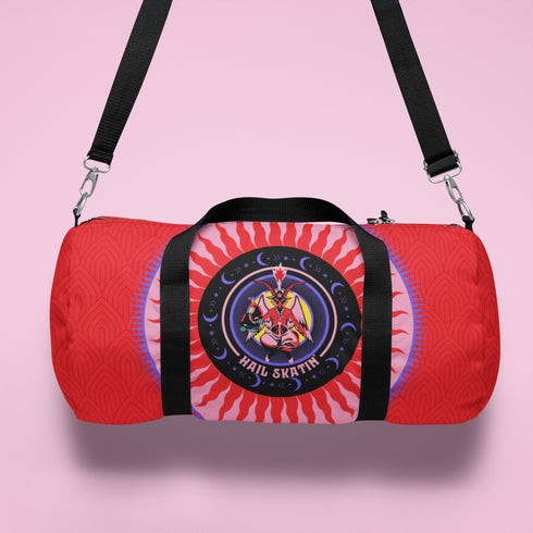 Red cylindrical roller skating duffle bag with black straps, featuring a prominent circular emblem with a colorful Baphomet design and "Hail Skatin" text. Includes mesh side pocket and adjustable padded shoulder strap.