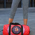 Red cylindrical roller skating duffle bag with black straps, featuring a prominent circular emblem with a colorful Baphomet design and "Hail Skatin" text. Includes mesh side pocket and adjustable padded shoulder strap.