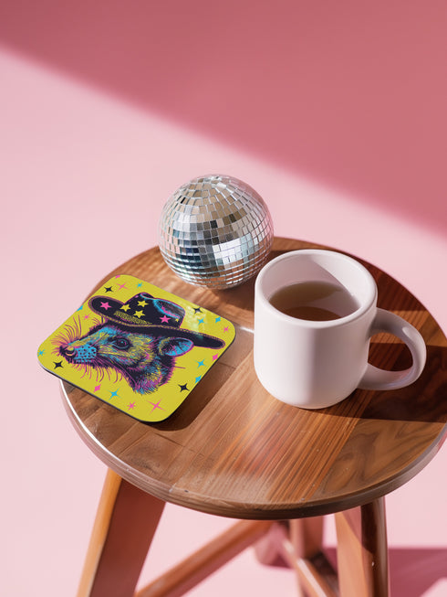 Square coasters featuring psychedelic multicolored possums wearing star-studded cowboy hats against bright neon yellow backgrounds with colorful stars. Weird trash panda drink coasters, funky possum barware, eclectic table decor, maximalist animal accessories.