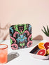 Square coasters featuring psychedelic blue cats with green eyes surrounded by baroque pink and green flourishes on black backgrounds. Gothic maximalist drink coasters for cat lovers, weird barware accessories, funky eclectic home decor, whimsigoth design.