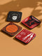 Four-piece horror movie coaster set featuring The Shining and Carrie designs in black, red, and orange with iconic quotes and imagery from the films. Cork-backed hardboard construction.