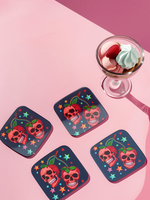 Square navy blue coasters featuring vibrant red cherry skulls with green stems and colorful star designs. Gothic drink coasters for maximalist home bar decor, whimsigoth table accessories perfect for weird decor enthusiasts and cocktail lovers.