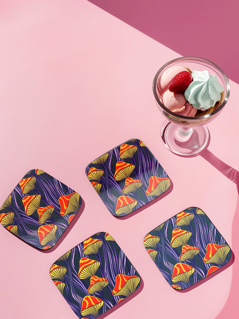 Square coasters featuring bright orange-red psychedelic mushrooms with yellow gills against deep purple background with flowing stems. Trippy magic mushroom drink coasters, funky retro barware, maximalist table decor, weird hippie home accessories.