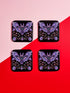 Square coasters featuring lavender-purple bats with folk art floral designs against black backgrounds. Pastel goth drink coasters, kawaii bat home decor, whimsigoth barware accessories, gothic floral table protection for weird home aesthetics.