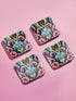 Square coasters featuring psychedelic blue cats with green eyes surrounded by baroque pink and green flourishes on black backgrounds. Gothic maximalist drink coasters for cat lovers, weird barware accessories, funky eclectic home decor, whimsigoth design.