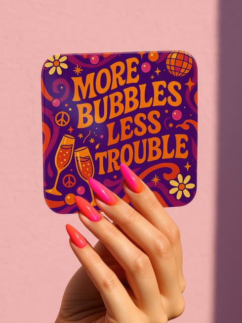 A 4-piece retro coaster set featuring colorful 70s-style cocktail graphics with playful drink quotes: "More Bubbles Less Trouble," "I Make Pour Decisions," "Cabernet All Day," and "Call Me Old-Fashioned." These 3.75” square coasters are made of Masonite with a glossy finish and cork backing—perfect for funky bar carts, dopamine décor, and retro hostess gifts.