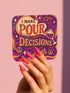 A 4-piece retro coaster set featuring colorful 70s-style cocktail graphics with playful drink quotes: "More Bubbles Less Trouble," "I Make Pour Decisions," "Cabernet All Day," and "Call Me Old-Fashioned." These 3.75” square coasters are made of Masonite with a glossy finish and cork backing—perfect for funky bar carts, dopamine décor, and retro hostess gifts.