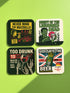 A set of four glossy square coasters on a vibrant green surface, each featuring a unique punk rock parody design. Top left: "Never Mind the Buzzkills" in yellow and pink ransom-note typography. Top right: "Night of the Liquored Dead" featuring a green zombie holding a drink in a horror comic style. Bottom left: "Too Drunk To Sip" with skeleton hands holding a wine glass on a black background. Bottom right: "God Save The Beer" featuring a green beer can on a Union Jack flag background.