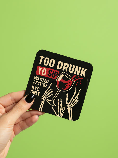 A set of four glossy square coasters on a vibrant green surface, each featuring a unique punk rock parody design. Top left: "Never Mind the Buzzkills" in yellow and pink ransom-note typography. Top right: "Night of the Liquored Dead" featuring a green zombie holding a drink in a horror comic style. Bottom left: "Too Drunk To Sip" with skeleton hands holding a wine glass on a black background. Bottom right: "God Save The Beer" featuring a green beer can on a Union Jack flag background.