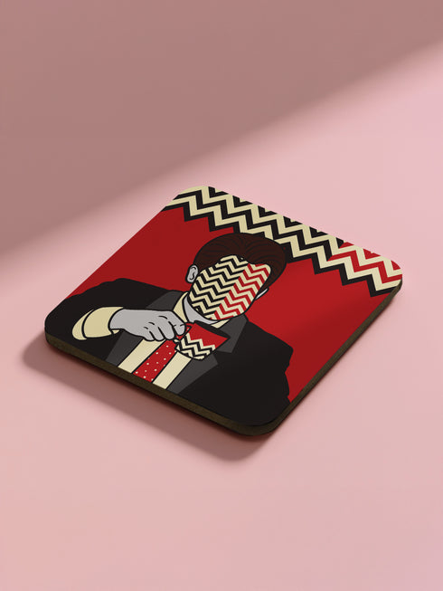 Four square coasters featuring Twin Peaks-inspired designs: Agent Cooper, the Log Lady, a coffee cup, and a mysterious blonde. Bold red backgrounds with black and white zigzag borders.