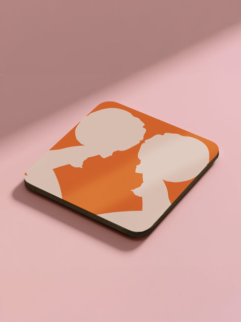 Set of four square coasters featuring iconic imagery from "A Clockwork Orange" in orange and white designs on a pink background.