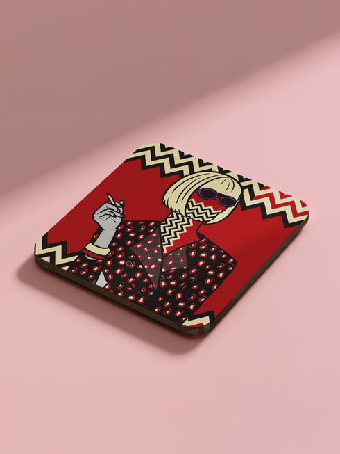 Four square coasters featuring Twin Peaks-inspired designs: Agent Cooper, the Log Lady, a coffee cup, and a mysterious blonde. Bold red backgrounds with black and white zigzag borders.