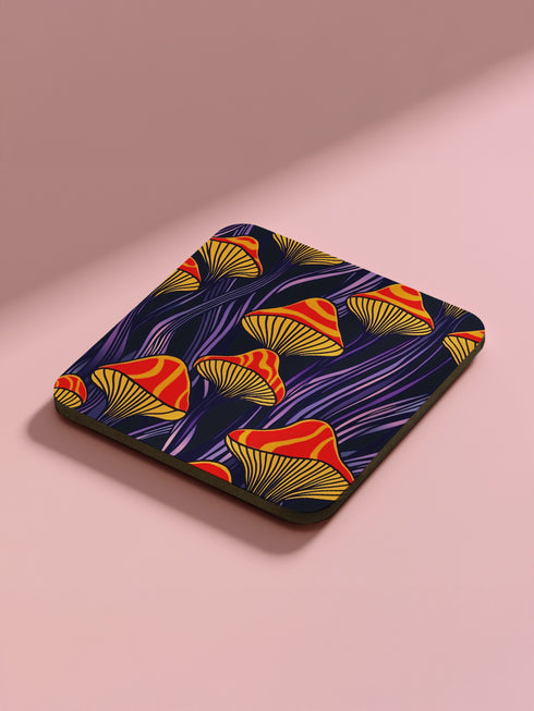 Square coasters featuring bright orange-red psychedelic mushrooms with yellow gills against deep purple background with flowing stems. Trippy magic mushroom drink coasters, funky retro barware, maximalist table decor, weird hippie home accessories.
