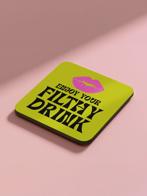 Four-piece coaster set featuring Divine/Pink Flamingos artwork with bold typography in pink, turquoise, and green. Includes "Toast to Trash," "Keeping Drinks Trashy," "Enjoy Your Filthy Drink," and Divine portrait designs.