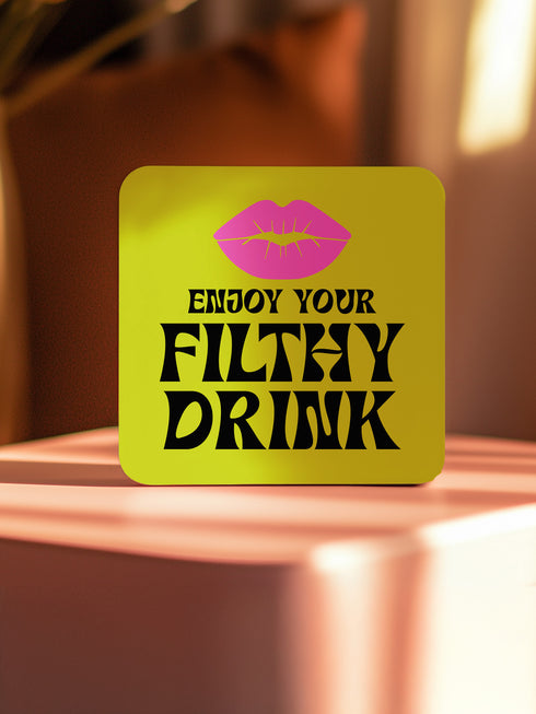 Four-piece coaster set featuring Divine/Pink Flamingos artwork with bold typography in pink, turquoise, and green. Includes "Toast to Trash," "Keeping Drinks Trashy," "Enjoy Your Filthy Drink," and Divine portrait designs.