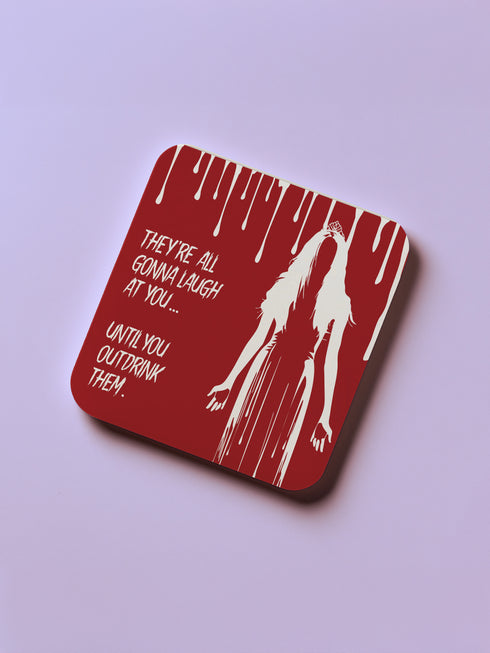 Four-piece horror movie coaster set featuring The Shining and Carrie designs in black, red, and orange with iconic quotes and imagery from the films. Cork-backed hardboard construction.