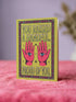 Funny Mother’s Day card in a 5x7 size featuring a vibrant chartreuse green background. The centralized design shows two pink hands with an electric blue eye in each palm, surrounded by cream stars. The retro bubble text reads "YOU RAISED A HANDFUL. PROUD OF YOU." A plum and pink geometric diamond border frames the card. This high-fidelity print mimics a 70s psychedelic art style with a flat matte or silk finish. A white sealable envelope is included with the handmade card.