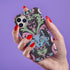 Phone case featuring baroque-style blue cat with green eyes surrounded by mint green foliage and pink flourishes on black background, Victorian-inspired desig