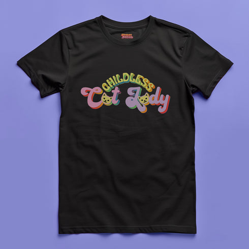 An election 2024 t-shirt with a colorful retro-style graphic that reads "Childless Cat Lady" across the chest. The text is in a playful, curvy font with each word in a different color - "Childless" in yellow-green, "Cat" in pink, and "Lady" in purple. Small cat face icons are incorporated into the letters 'a' in "Cat" and "Lady".