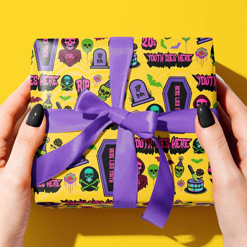 30th Birthday Wrapping Paper, darkly humorous wrapping paper with neon skulls, tombstones, coffins, and phrases like "Youth Dies Here" and "RIP 20s."