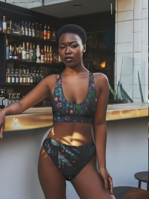 Black Cherry floral bikini top with deep V neckline, bold pink and purple tropical flowers, glossy leaves, and subtle fruit pattern. Made with recycled polyester and LYCRA, removable padding, double-layered, available in sizes XS to 3XL, features UPF 50 plus sun protection, non-reversible. Designed for festival, rave, and retro summer swim looks.