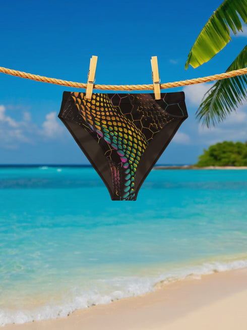 High-waisted bikini bottom featuring a holographic snake scale print with neon rainbow tones on a sleek black background. Iridescent hexagon patterns add a futuristic edge. Cheeky fit with a double-layered finish, styled poolside against a bright turquoise water backdrop. Perfect for rave-ready swim looks, alternative beachwear, and bold festival swimwear with a Y2K cyberpunk twist.