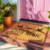 Tan coir doormat featuring "Welcome, Hope You Like Goth Music" in black text, with bat and skull imagery and gothic-style corner decorations.