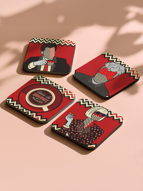 Four square coasters featuring Twin Peaks-inspired designs: Agent Cooper, the Log Lady, a coffee cup, and a mysterious blonde. Bold red backgrounds with black and white zigzag borders.