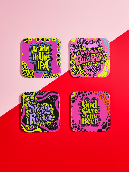A four-piece punk rock-inspired coaster set featuring neon pink, yellow, and black designs with bold typography and chaotic patterns.