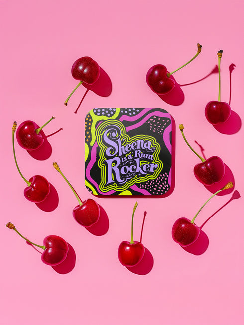 A four-piece punk rock-inspired coaster set featuring neon pink, yellow, and black designs with bold typography and chaotic patterns.