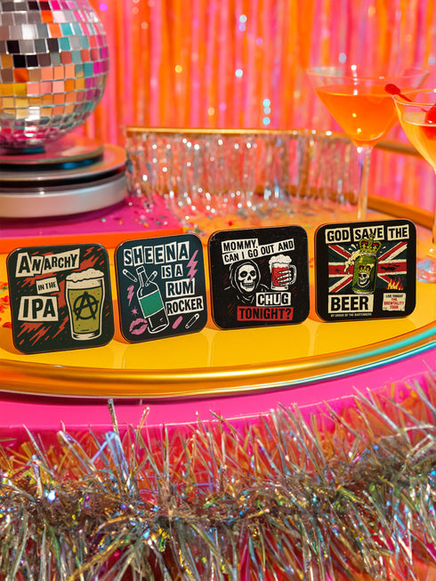 A 4-piece square coaster set featuring punk rock-inspired designs in a bold, vintage art style. Includes slogans like “Sheena Is A Rum Rocker,” “God Save the Beer,” and “Anarchy in the IPA.” Made of Masonite with cork backing, these 3.75 x 3.75-inch coasters are perfect for music lovers, goth homes, and alternative wedding or housewarming gifts.
