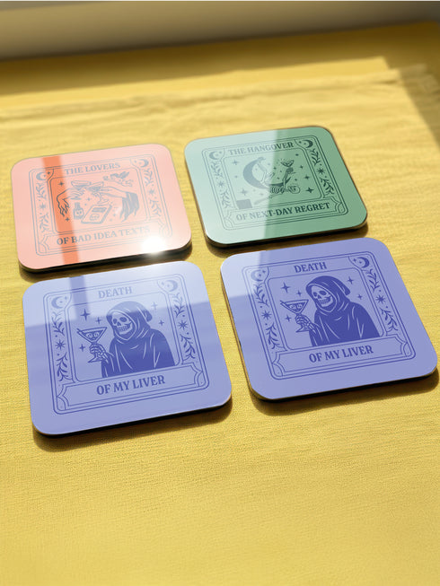 A set of four square coasters featuring humorous tarot card designs in pastel colors. The set includes a pink coaster titled 'High Priestess of Pour Decisions' showing a witch holding a goblet, a purple coaster titled 'Death of My Liver' depicting a skeleton holding a martini, an orange coaster titled 'The Lovers of Bad Idea Texts' featuring two hands toasting, and a green coaster titled 'The Hangover of Next-Day Regret' showing a skeleton falling. Glossy finish.