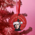 "Round red metal Christmas ornament featuring Nick Cave in black and white with Santa hat, Nordic patterns, and 'Where The Wild Mistletoes Grow' text, suspended by red ribbon