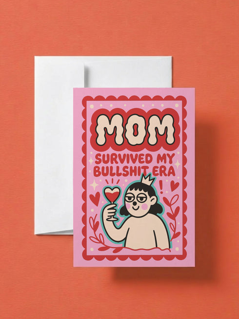 A 5x7 inch flat-printed pink greeting card featuring a cherry red scalloped border. At the top, bold wavy cream letters outlined in red read MOM. Below, red text says SURVIVED MY BULLSHIT ERA surrounded by small stars and hearts. The center illustration shows a smirking figure with black hair wearing small crown and holding a heart-shaped glass of \wine, outlined in light teal. The inside features black serif text: Bullshit era survivor award: you. Grateful you didn't quit on me. Love you, Mom.